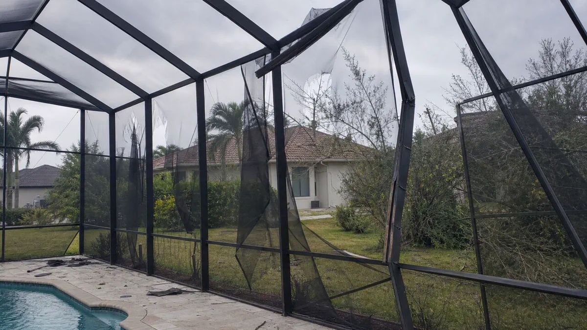 Pool screen enclosure hurricane damage before repair Cape Coral